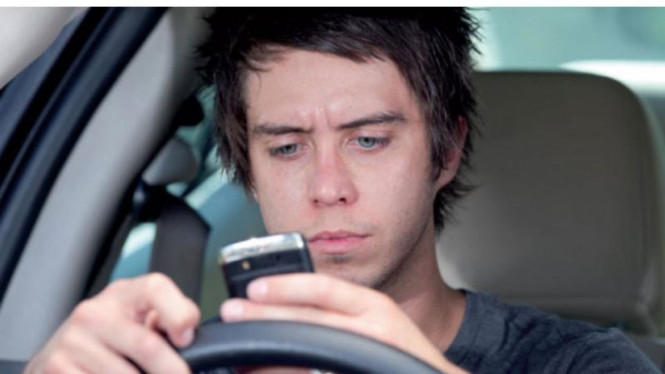 Mengemudi mobil sambil menggunakan smartphone untuk jejaring sosial