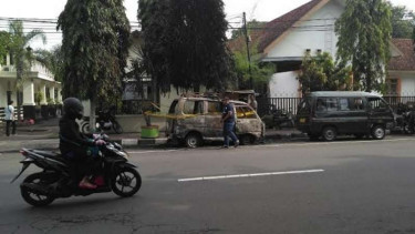 Mobil angkutan umum yang terparkir di depan Polsek Kediri dan Gereja Getsmani di Kota Kediri dibakar orang tak dikenal, Selasa (15/11/2016)