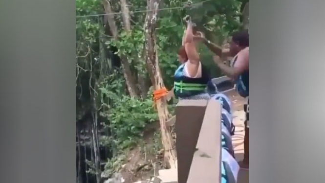 Wanita tambun menjajal permainan flying fox.
