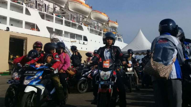 Para pemudik dengan sepeda motor saat turun dari kapal.