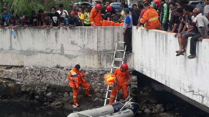 Pencarian buaya di  Kali Grogol, Jalan Latumenten, Jakarta Barat.