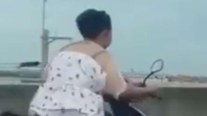 Emak-emak naik motor masuk tol.