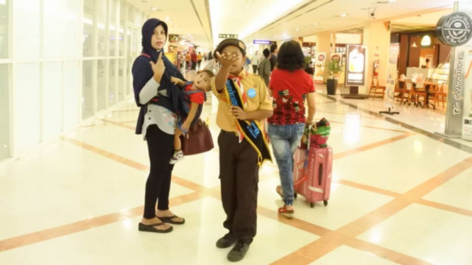 Seorang siswa SD sedang berperan sebagai petugas bandara 