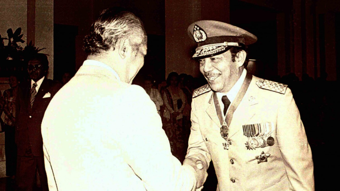 Presiden Soeharto (kiri) memberikan ucapan selamat kepada Letjen Polisi Awaloedin Djamin (kanan) saat pelantikannya sebagai Kapolri yang baru menggantikan Jenderal Polisi Widodo Budidarmo di Istana Negara, Jakarta, 25 September 1978.
