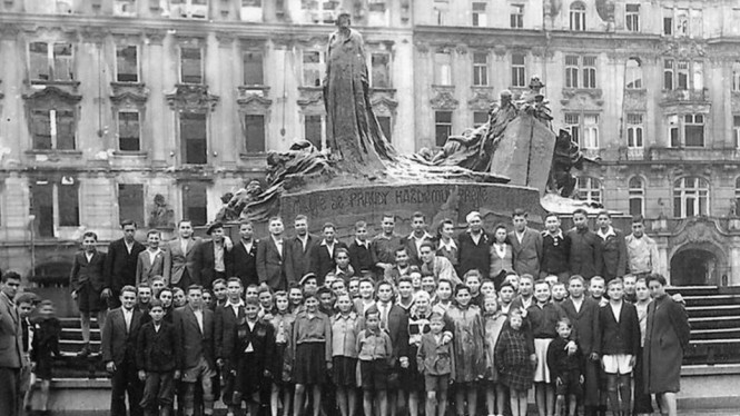 Korban selamat dan keluarga mereka berfoto berdasarkan foto tahun 1945 ini. - Lake District Holocaust Project