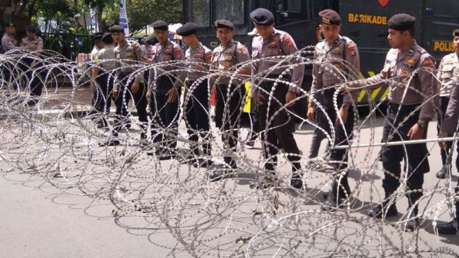 Polisi memasang kawat berduri di Jalan Medan Merdeka Barat, Jakarta.