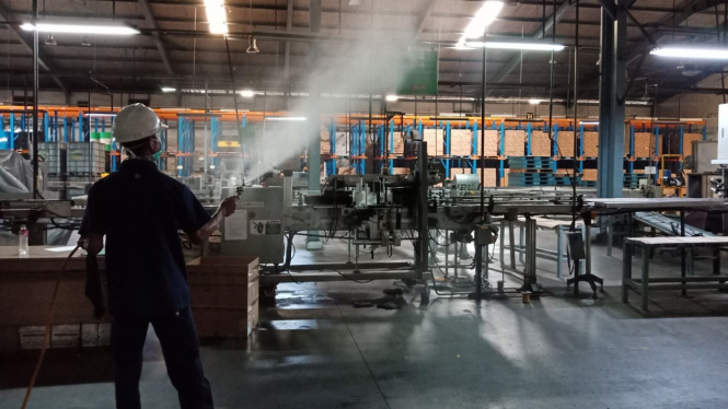Penyemprotan disinfektan di pabrik 