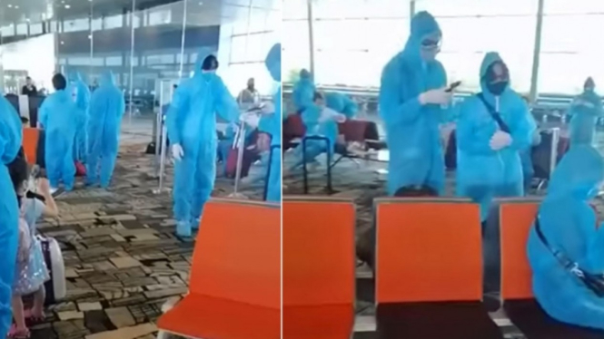 Penumpang asal Vietnam gunakan APD di Bandara Changi, Singapura. 