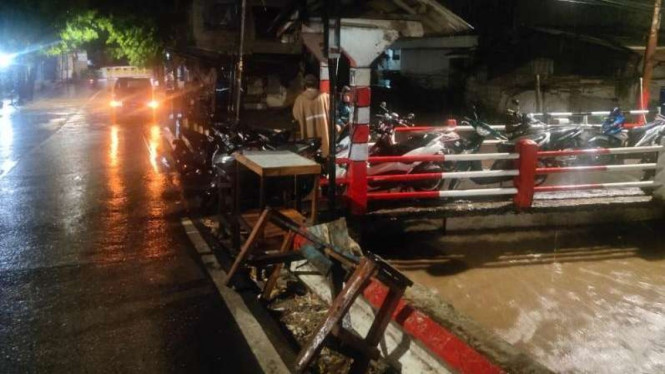 Warga Pondok labu mengungsikan motor mereka ke jalan raya.