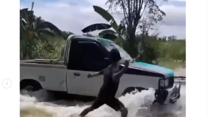 Isuzu Panther terobos genangan banjir di Gresik.
