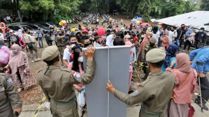 Aparat Satpol PP menertibkan para warga pengunjung Kebun Binatang Kota Bandung untuk disiplin menerapkan protokol kesehatan pencegahan COVID-19 dalam satu operasi razia, Minggu, 16 Mei 2021.