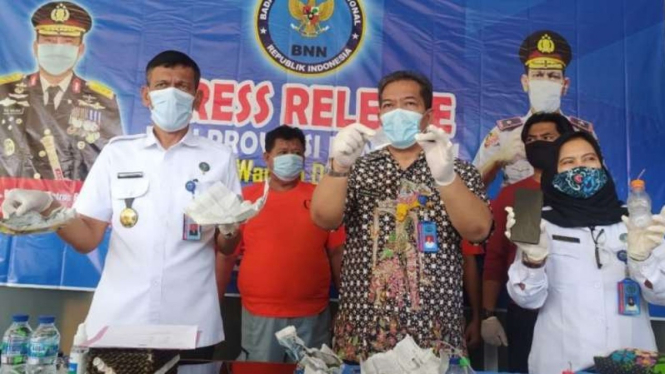 Kepala BNN Provinsi Bengkulu Brigjen Pol Toga Habinsar Panjaitan memperlihatkan barang bukti narkoba dan tersangka pengedarnya yang seorang oknum polisi dalam konferensi pers di Bengkulu, Selasa, 25 Mei 2021.