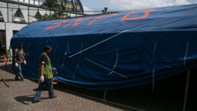 Relawan membangun tenda barak di Rumah Sakit Umum Pusat Dr. Sardjito, Sleman, DI Yogyakarta, Minggu, 27 Juni 2021, untuk mengantisipasi membludaknya pasien COVID-19 seiring lonjakan kasus penularan.