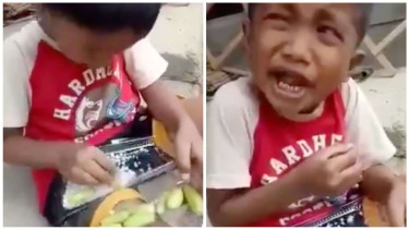 seorang bocah makan belimbing wuluh