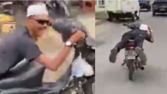 Pria mengendarai motor sambil tiduran
