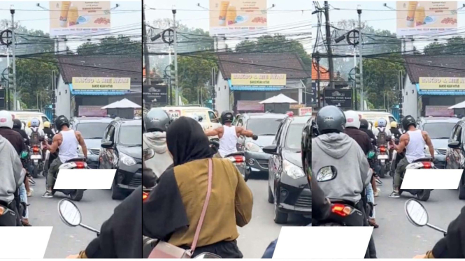 Seorang Pengendara Sepeda Motor Angkat Barbel di Tengah Kemacetan Jalan