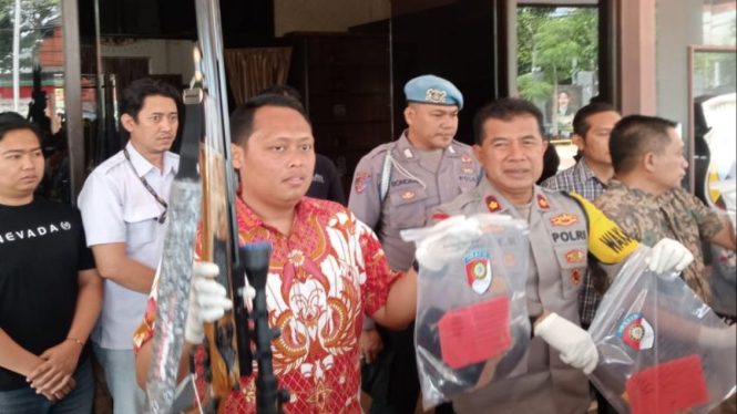 Polisi saat menunjukkan senapan angin yang digunakan menembak korban