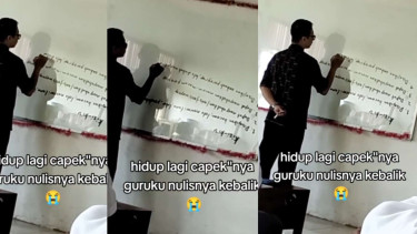 Guru Menulis dengan Huruf Terbalik di Papan Tulis