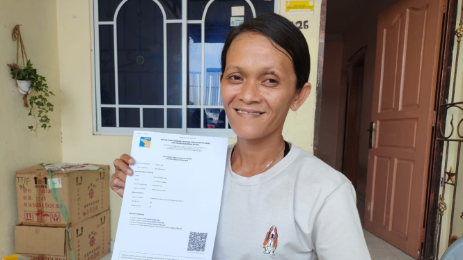 Warga Rempang, Wulan, menunjukan dokumen berita acara serah terima dari BP Batam