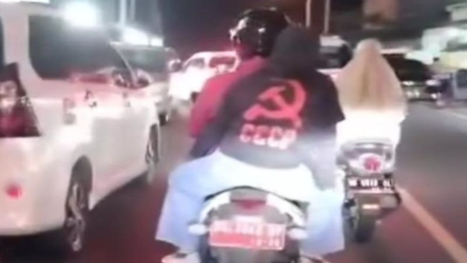 Wanita Asal Sulawesi Utara pakai Kaos palu arit saat melintas di Kota Ternate. 