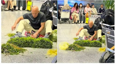 Bule lagi beberes kangkung di bandara.