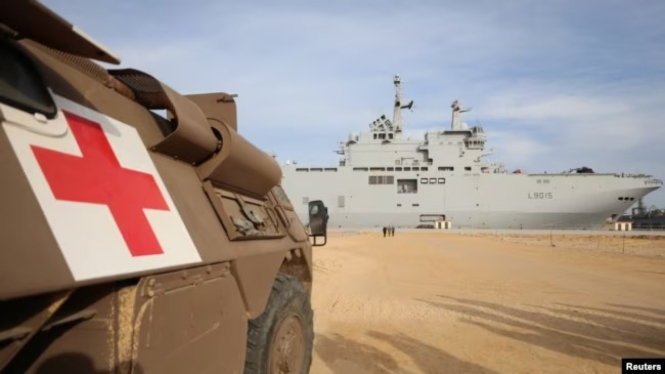 A military medical vehicle stands near the French ship amphibious helicopter carrier Dixmude (VOA News)