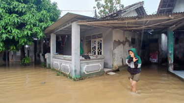 Warga yang sedang menerjang banjir usai air rendam rumahnya di Desa cirarab, tangerang