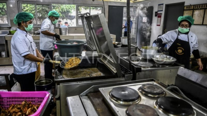 Petugas menyiapkan paket makanan bergizi gratis (MBG)