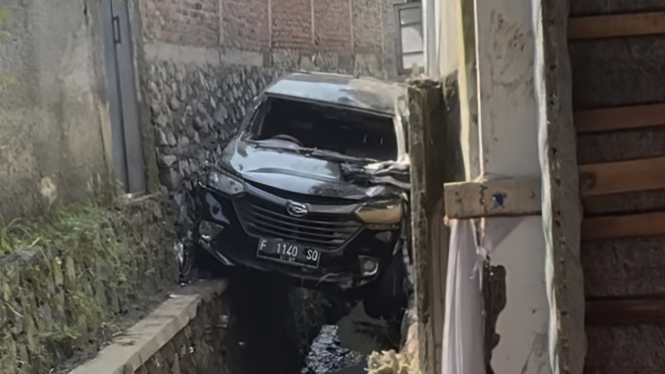 Mobil terhimpit bangunan akibat terbawa arus banjir